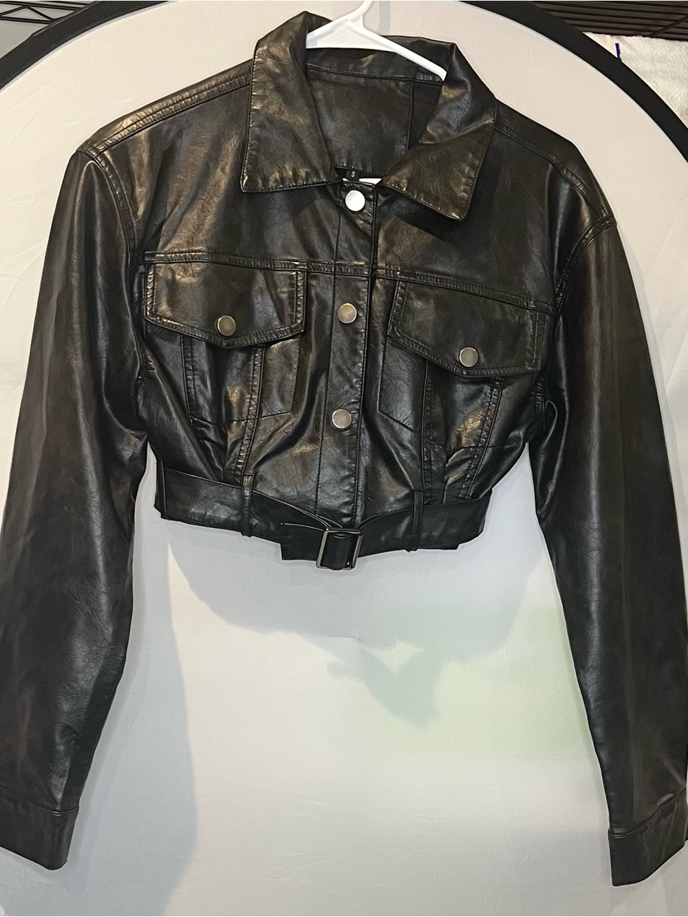 Cropped Black Leather Jacket with Snap Pockets and Belted Hem